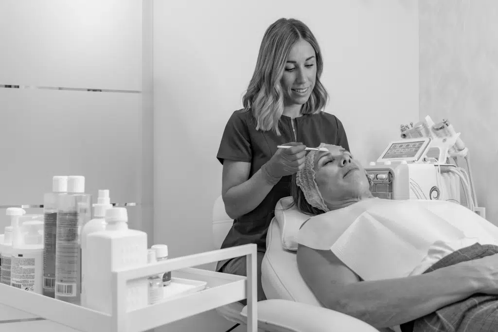 empowered esthetician giving a client a facial knowing they're insured by BeautyGuard